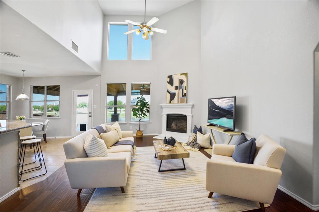 14904 Riverside Drive Little Elm, TX 75068 - Photo 12 of 28 a living room with furniture a fireplace and a chandelier