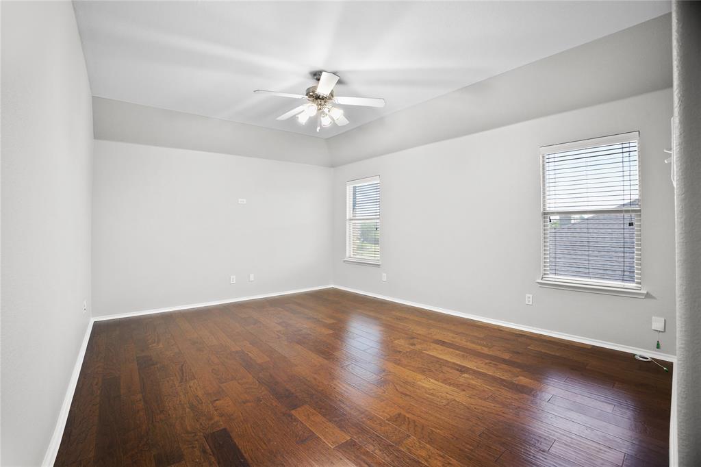 14904 Riverside Drive Little Elm, TX 75068 - Photo 21 of 28 a view of an empty room with wooden floor and a window