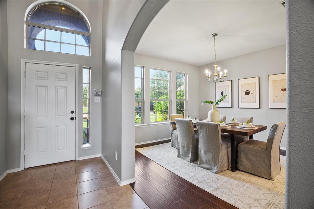 14904 Riverside Drive Little Elm, TX 75068 - Photo 4 of 28 a dining room with furniture a chandelier and wooden floor