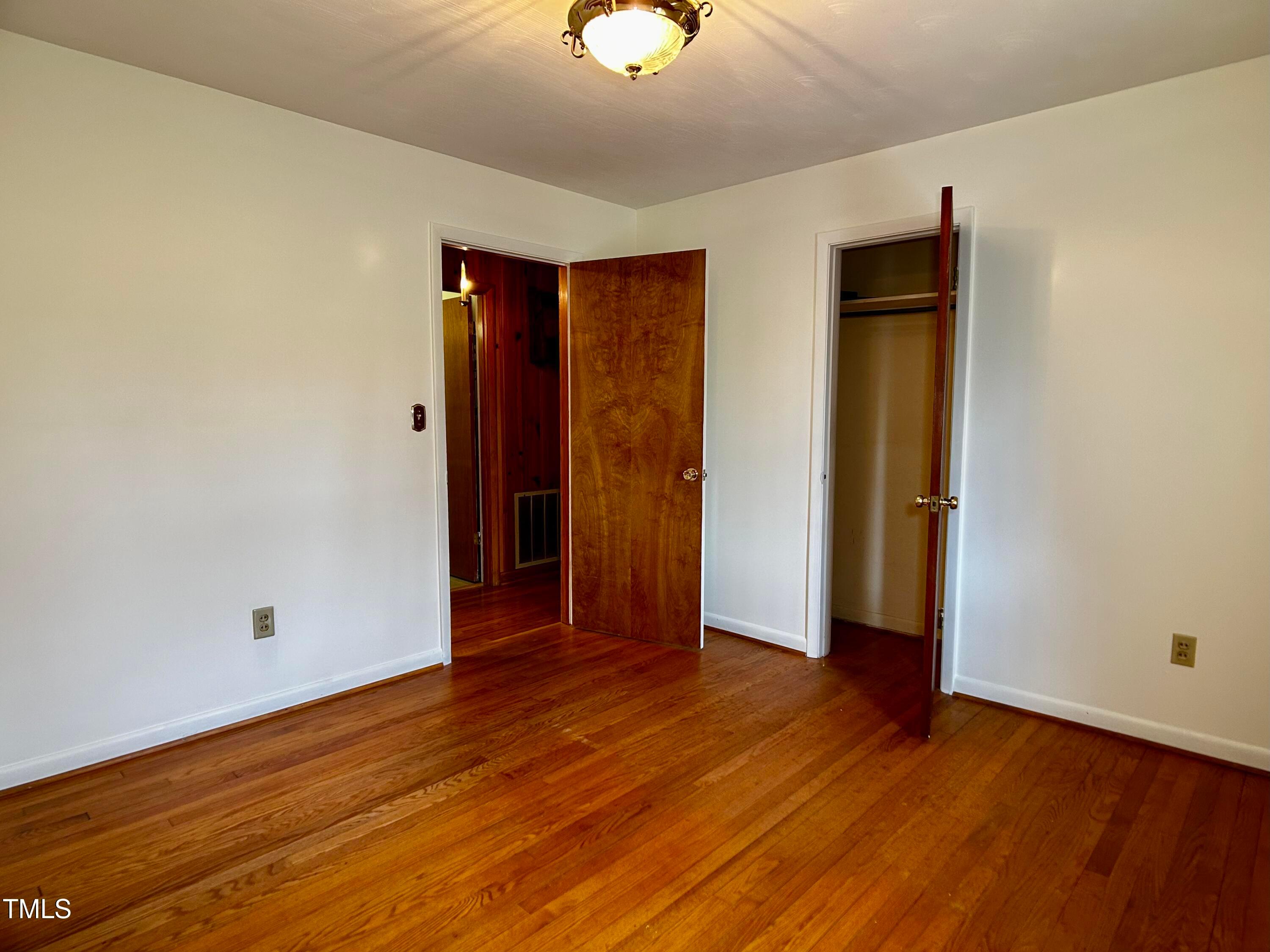 2981 Barber Mill Road Clayton, NC 27520 - Photo 13 of 28 an empty room with wooden floor and closet