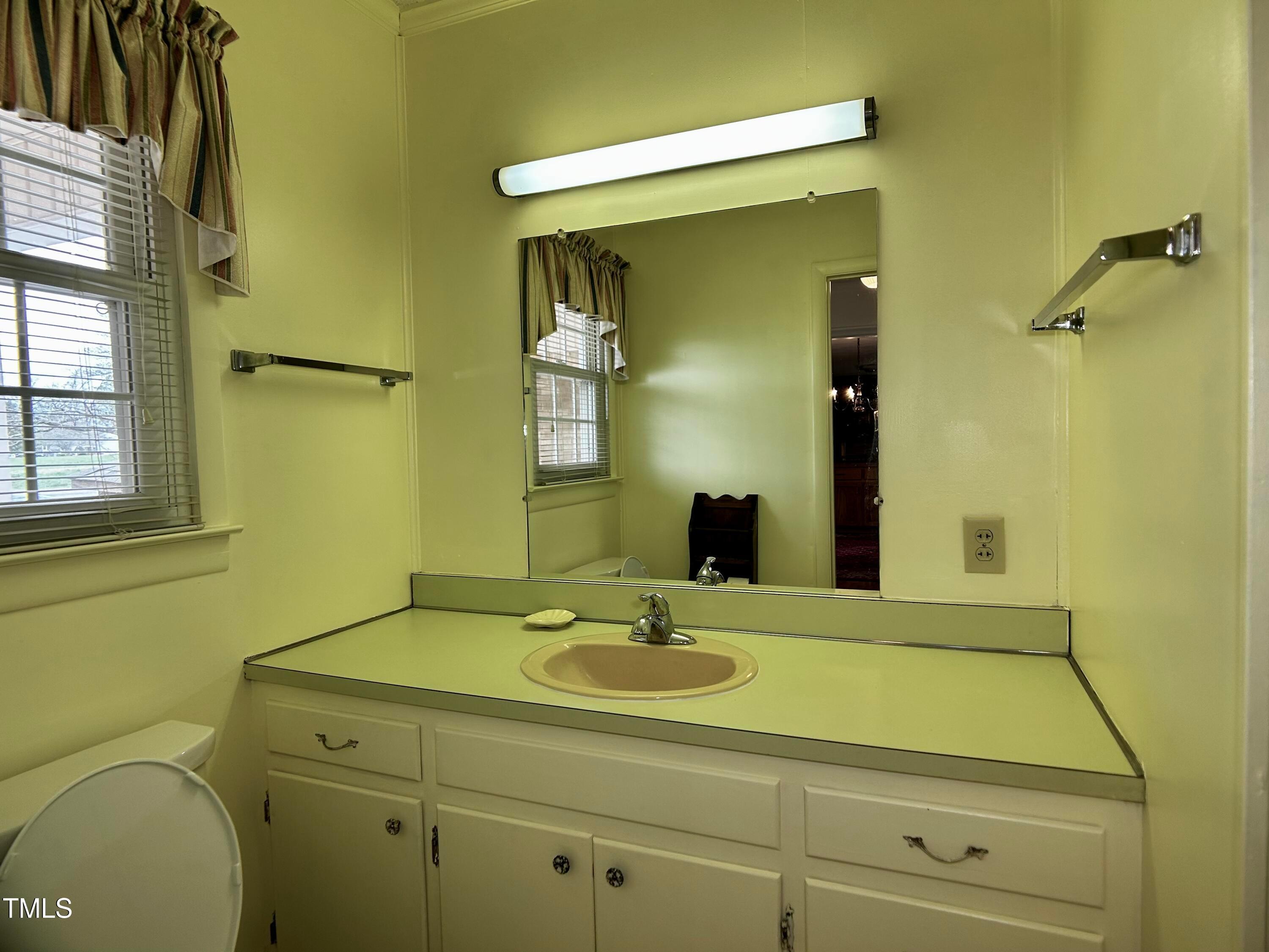 2981 Barber Mill Road Clayton, NC 27520 - Photo 19 of 28 a bathroom with a sink and a mirror