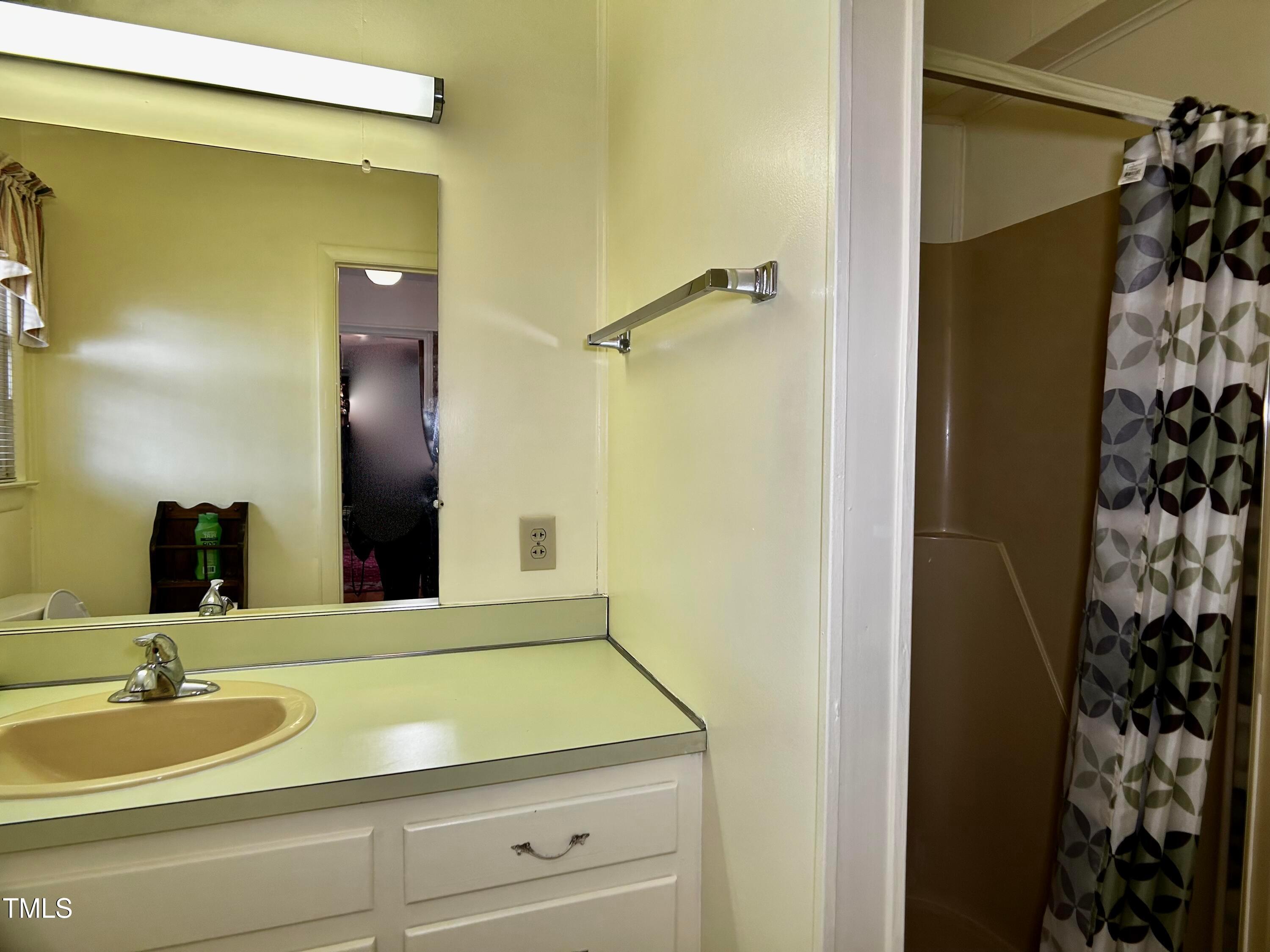 2981 Barber Mill Road Clayton, NC 27520 - Photo 20 of 28 a bathroom with a granite countertop sink and a mirror