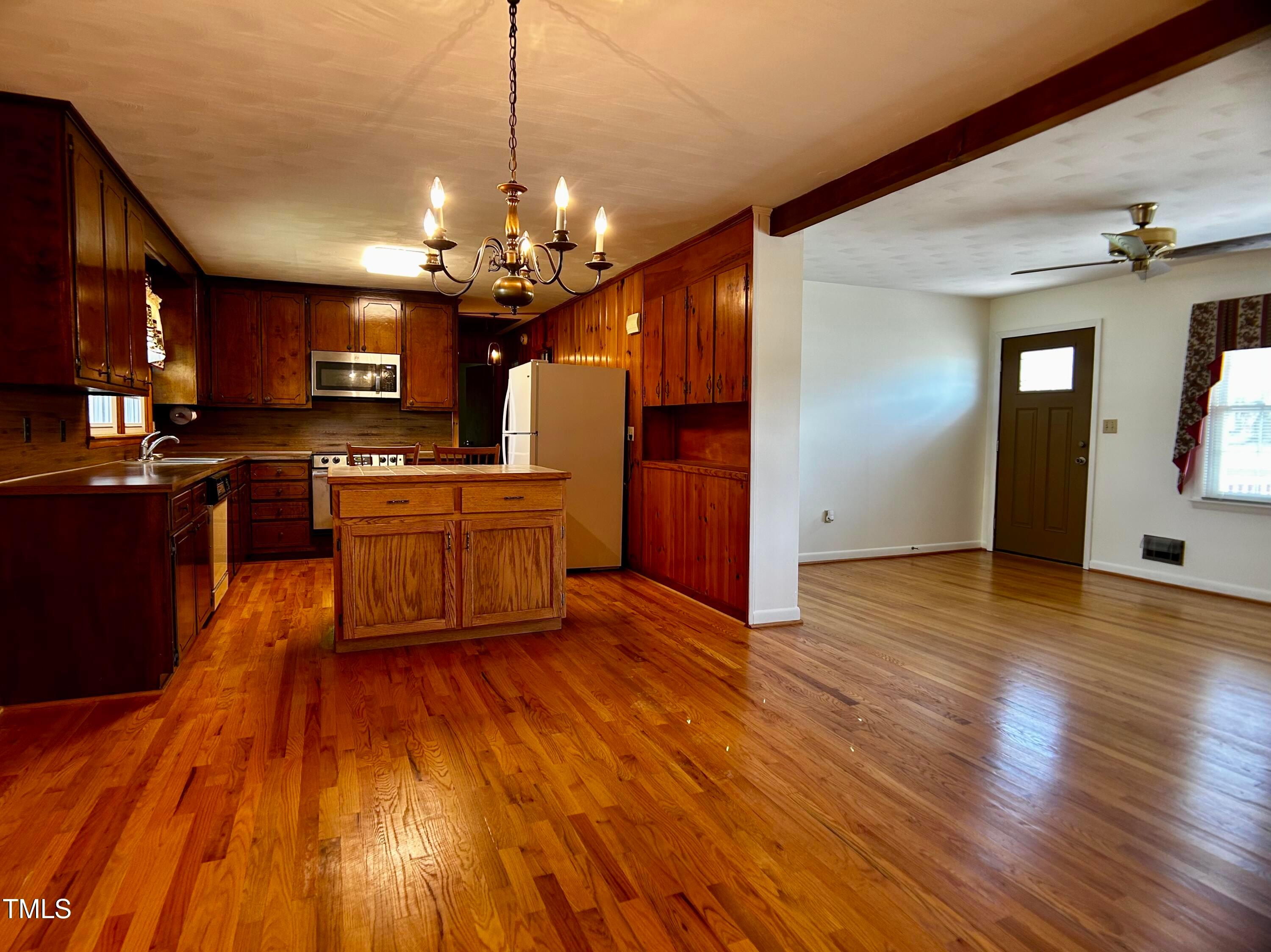 2981 Barber Mill Road Clayton, NC 27520 - Photo 5 of 28 a large kitchen with stainless steel appliances granite countertop wooden floors and granite counter tops
