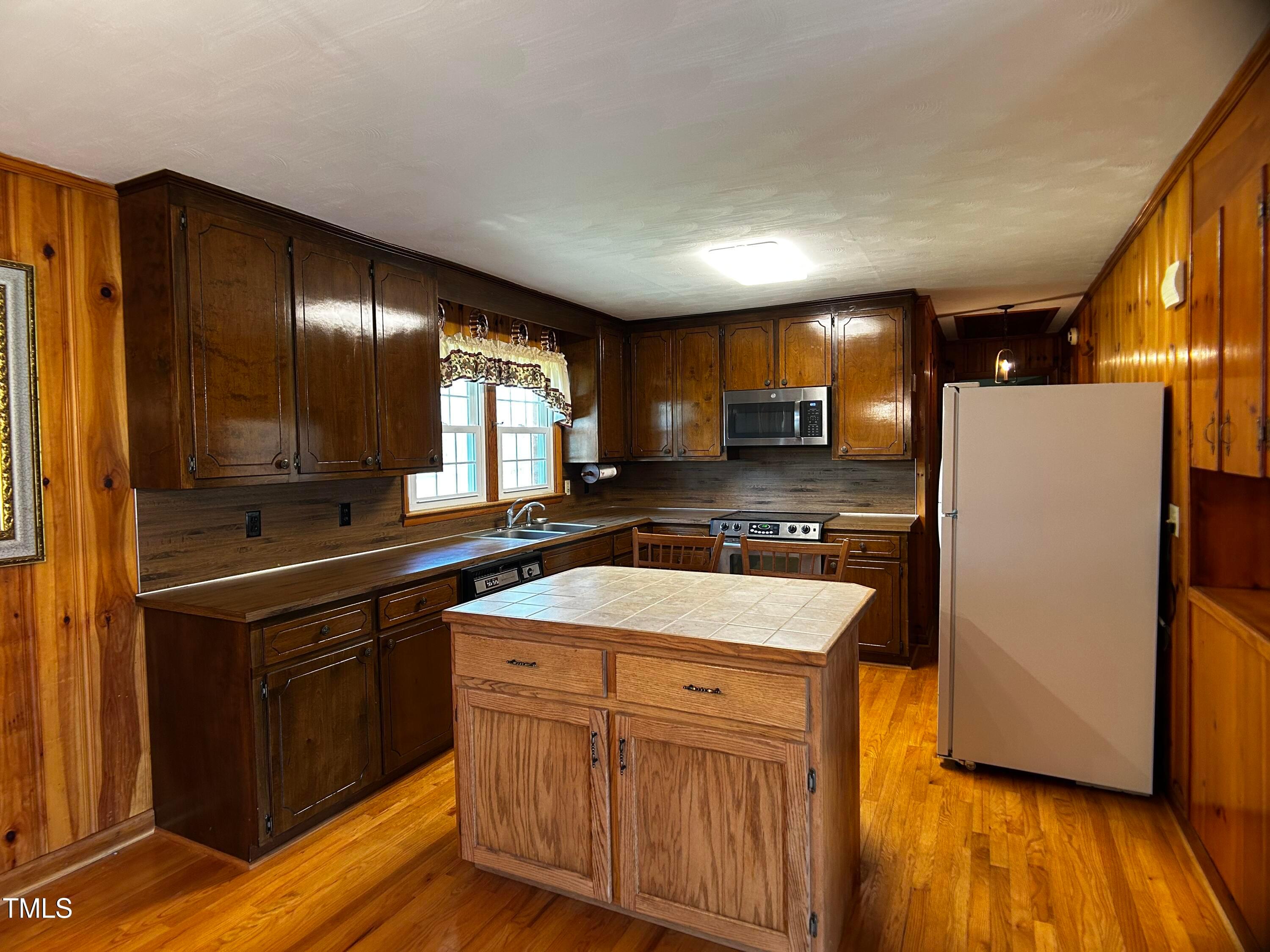 2981 Barber Mill Road Clayton, NC 27520 - Photo 6 of 28 a kitchen with stainless steel appliances granite countertop wooden cabinets a sink and dishwasher