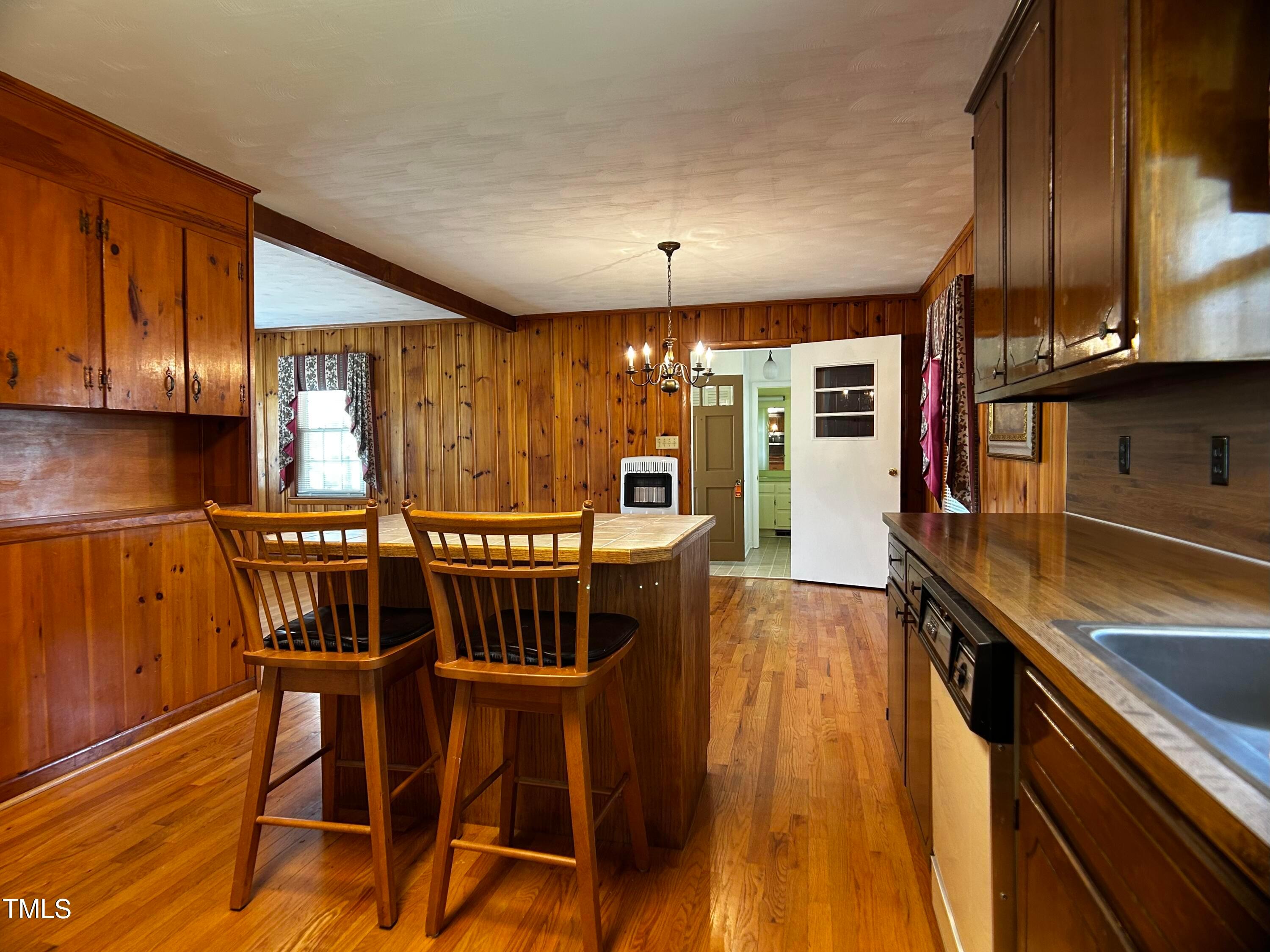 2981 Barber Mill Road Clayton, NC 27520 - Photo 7 of 28 a kitchen with stainless steel appliances granite countertop a table chairs sink and cabinets