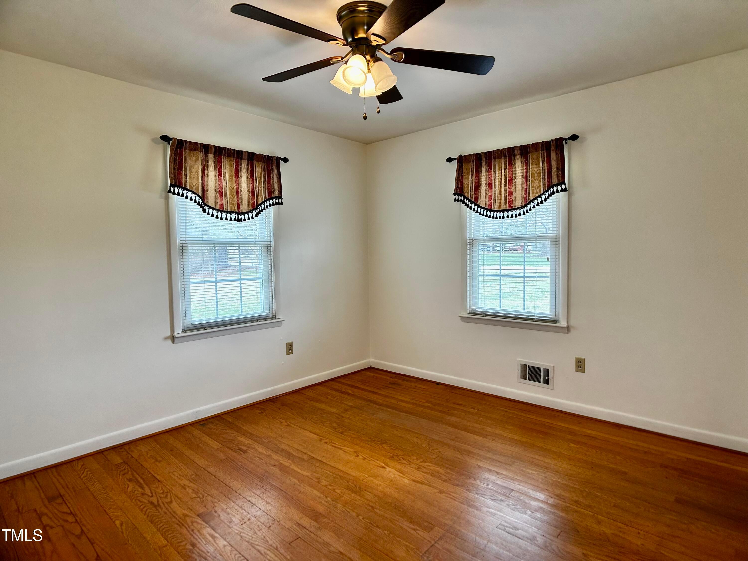 2981 Barber Mill Road Clayton, NC 27520 - Photo 10 of 28 a view of an empty room with a window and wooden floor