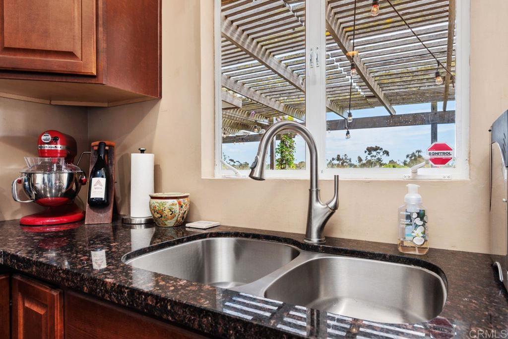 1107 Prospect Circle Vista, CA 92081 - Photo 14 of 52 a kitchen sink with granite countertop a sink and a window