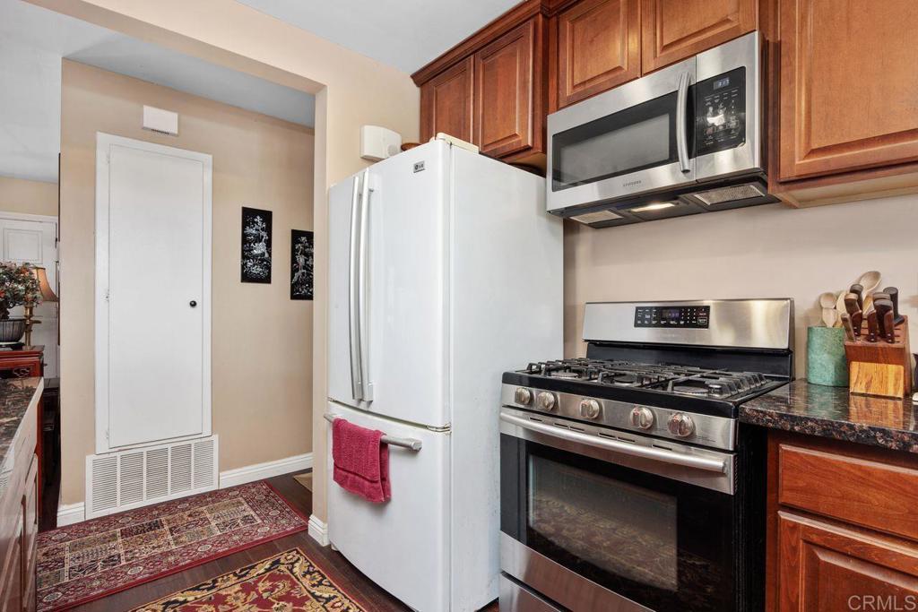 1107 Prospect Circle Vista, CA 92081 - Photo 15 of 52 a kitchen with stainless steel appliances granite countertop a refrigerator and a stove top oven