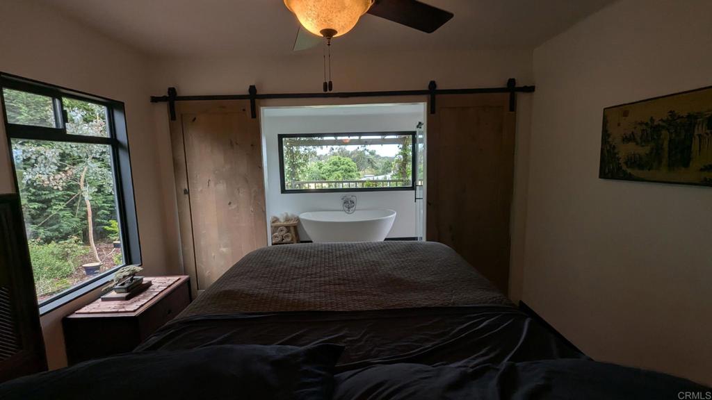 1107 Prospect Circle Vista, CA 92081 - Photo 19 of 52 a bedroom with a bed window and flat screen tv