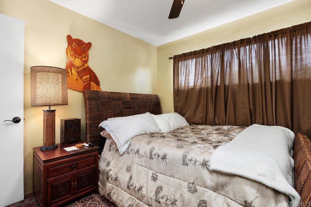 1107 Prospect Circle Vista, CA 92081 - Photo 27 of 52 a bedroom with a bed and a chandelier