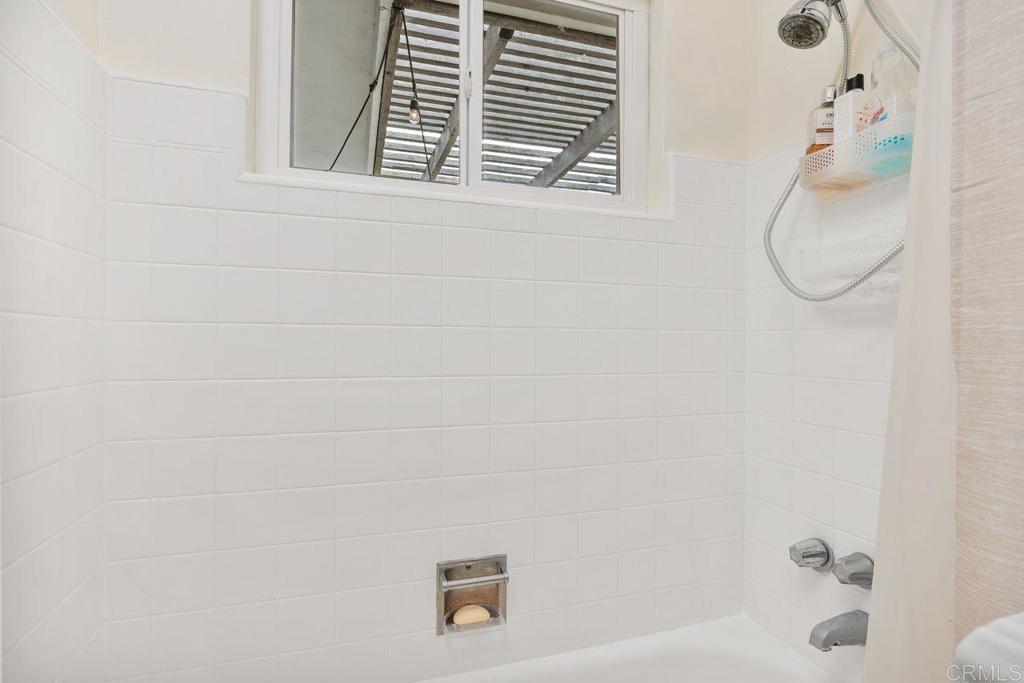1107 Prospect Circle Vista, CA 92081 - Photo 30 of 52 a bathroom with a bath tub and a shower curtain