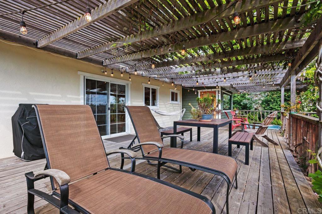 1107 Prospect Circle Vista, CA 92081 - Photo 32 of 52 a view of a patio with table and chairs with wooden floor and fence
