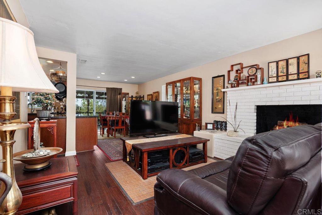 1107 Prospect Circle Vista, CA 92081 - Photo 4 of 52 a living room with furniture a fireplace and a large window