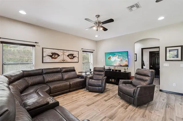 a living room with furniture and a wooden floor