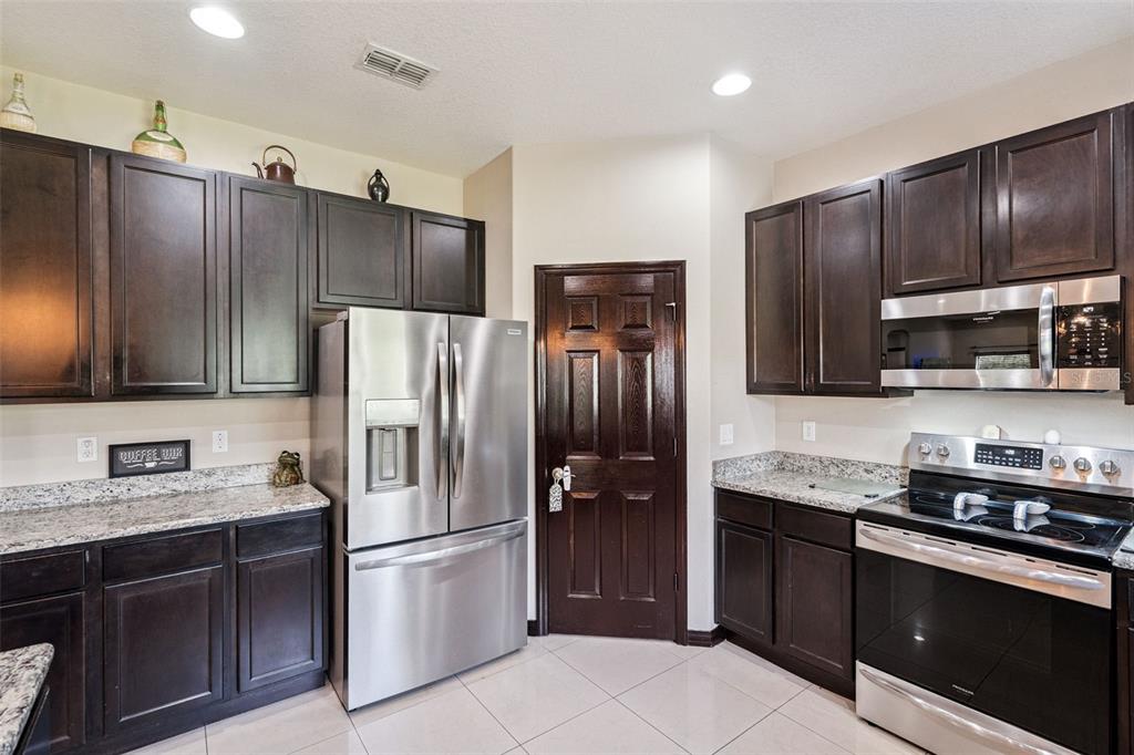 127 Verde Way DeBary, FL 32713 - Photo 17 of 83 a kitchen with stainless steel appliances granite countertop a refrigerator and a sink