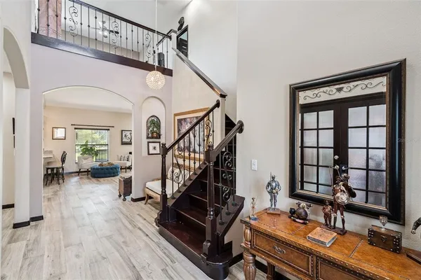 a kitchen with stainless steel appliances kitchen island granite countertop a stove a sink a refrigerator and chairs
