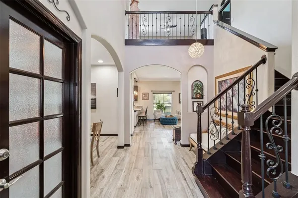 a view of staircase with wooden floor and a large window