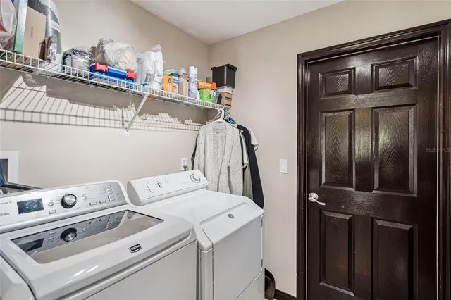 a front view of multi story residential apartment building with yard and green space