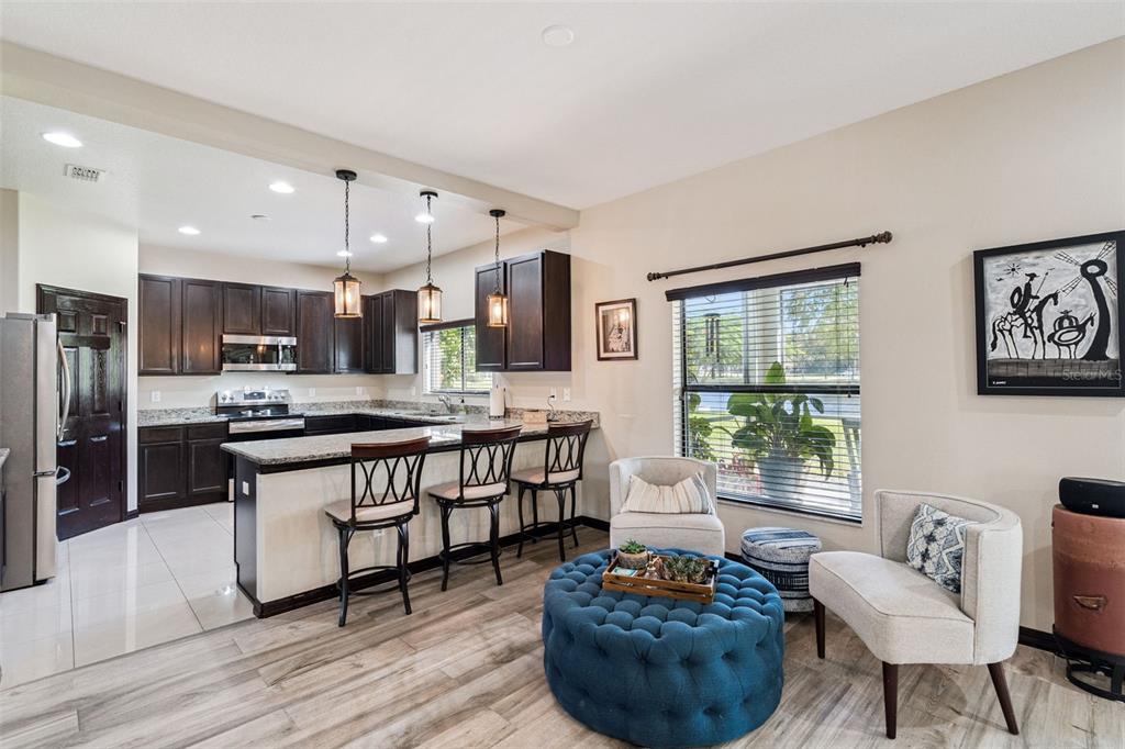 127 Verde Way DeBary, FL 32713 - Photo 24 of 77 a kitchen with stainless steel appliances kitchen island granite countertop a stove a sink a refrigerator and chairs