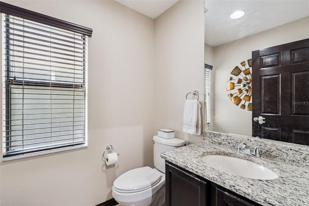 127 Verde Way DeBary, FL 32713 - Photo 27 of 77 a bathroom with a granite countertop sink toilet and mirror