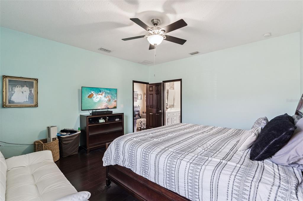 127 Verde Way DeBary, FL 32713 - Photo 32 of 77 a bedroom with a bed and dresser with wooden floor