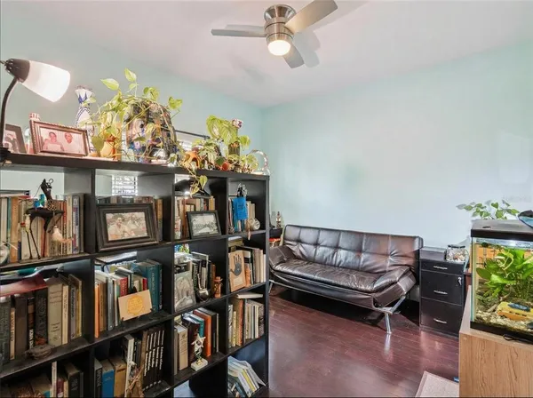 a dining room with wooden floor a chandelier a wooden table and chairs