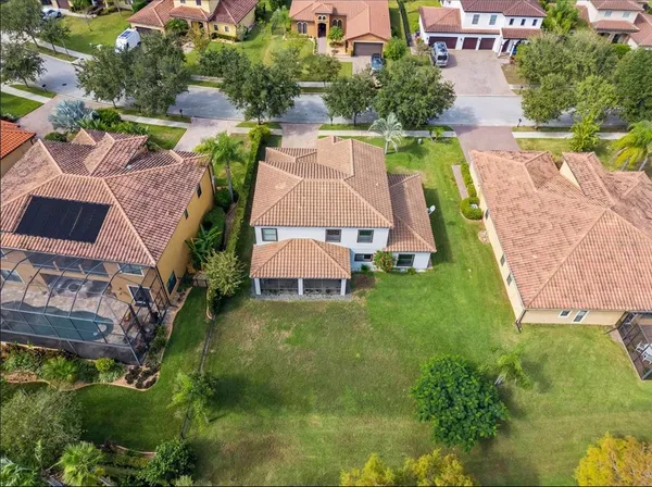 an aerial view of a house with outdoor space pool patio and lake view