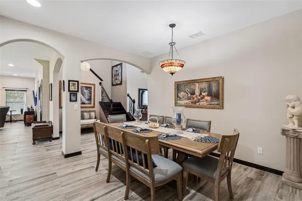 a living room with furniture ceiling fan and a wooden floor
