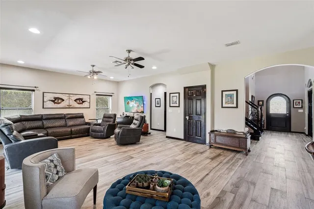a kitchen with stainless steel appliances kitchen island granite countertop a sink stove and refrigerator