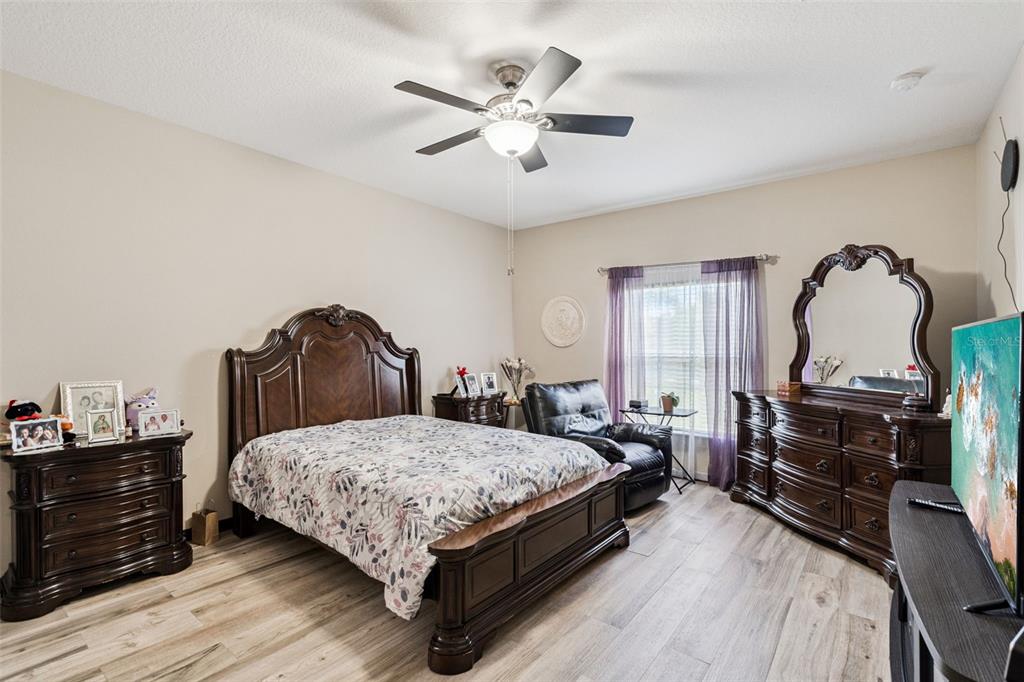 127 Verde Way DeBary, FL 32713 - Photo 10 of 77 a bedroom with a bed and wooden floor