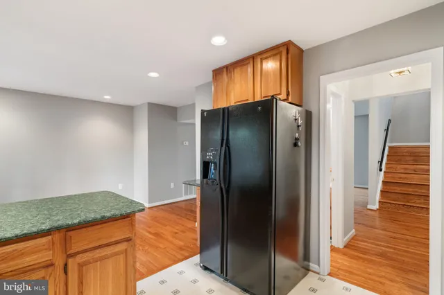 a view of a kitchen with wooden floor and staircase