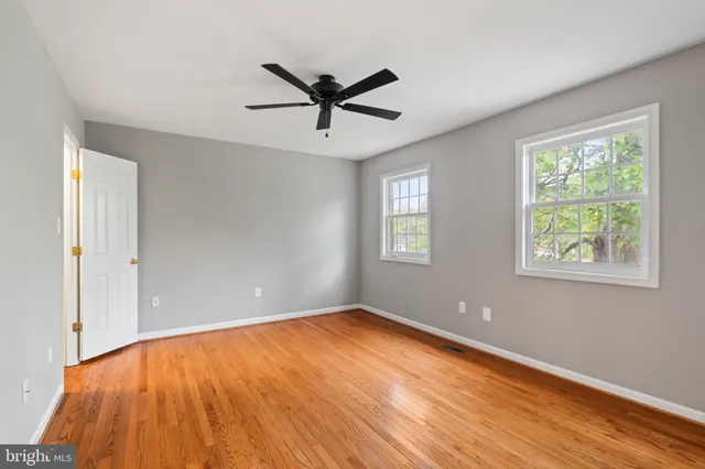 a view of empty room with wooden floor