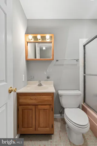 a view of an empty room with wooden floor and stairs