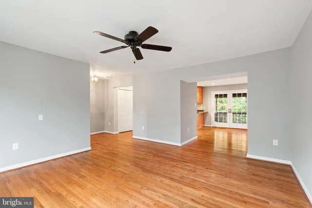 a view of empty room with wooden floor and window