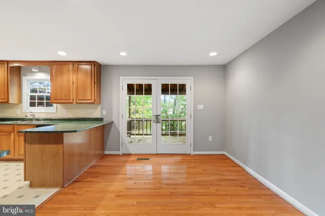 a large hall with stainless steel appliances granite countertop a large window