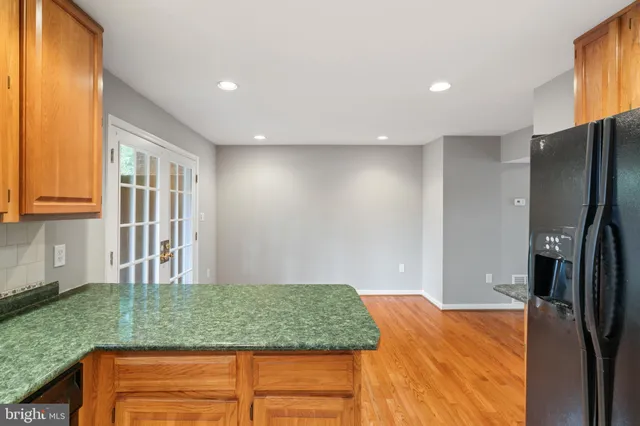a kitchen with kitchen island a counter top space cabinets and stainless steel appliances