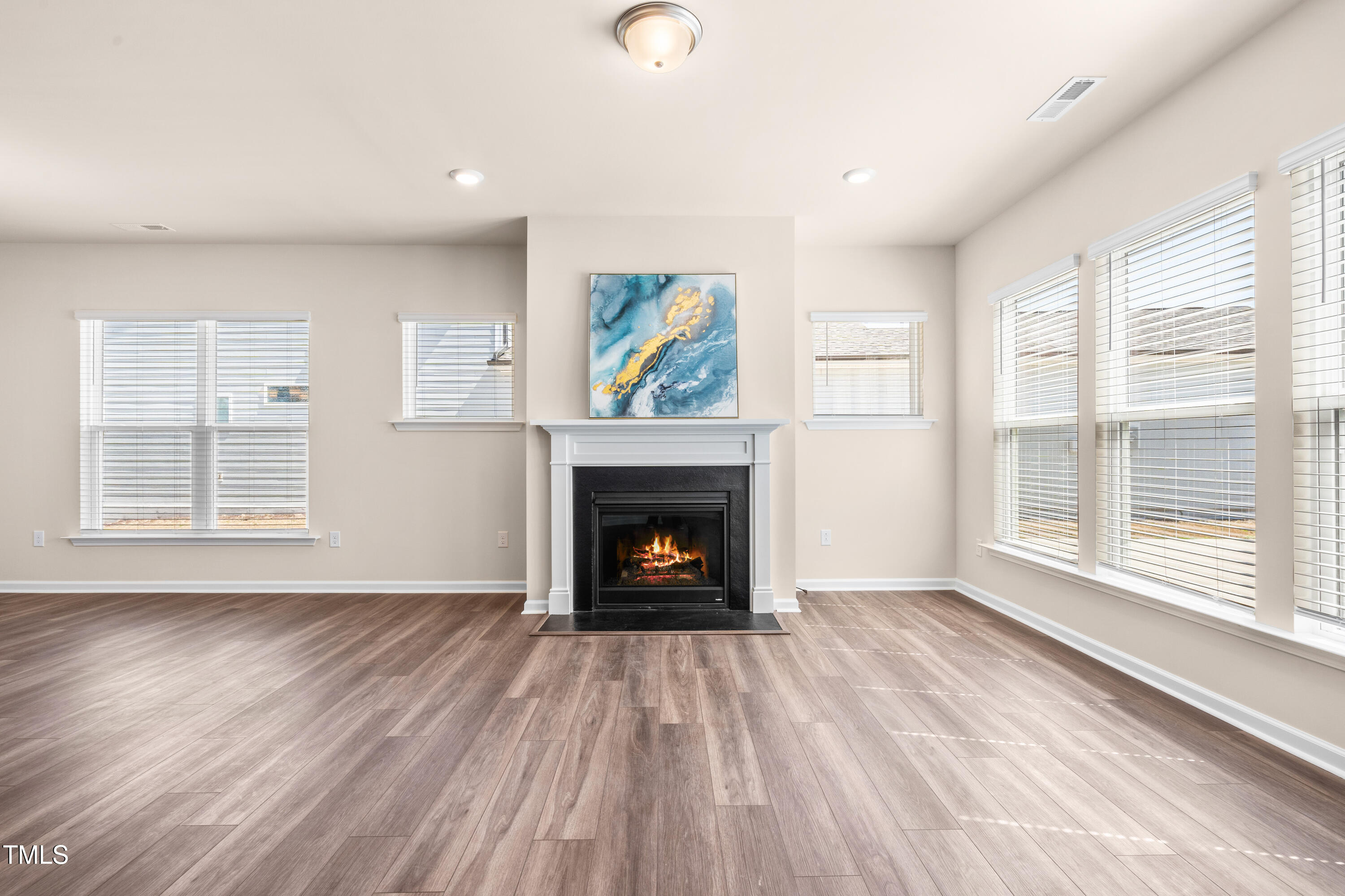 5800 Agrinio Way Raleigh, NC 27603 - Photo 11 of 38 a view of an empty room with a window and fireplace