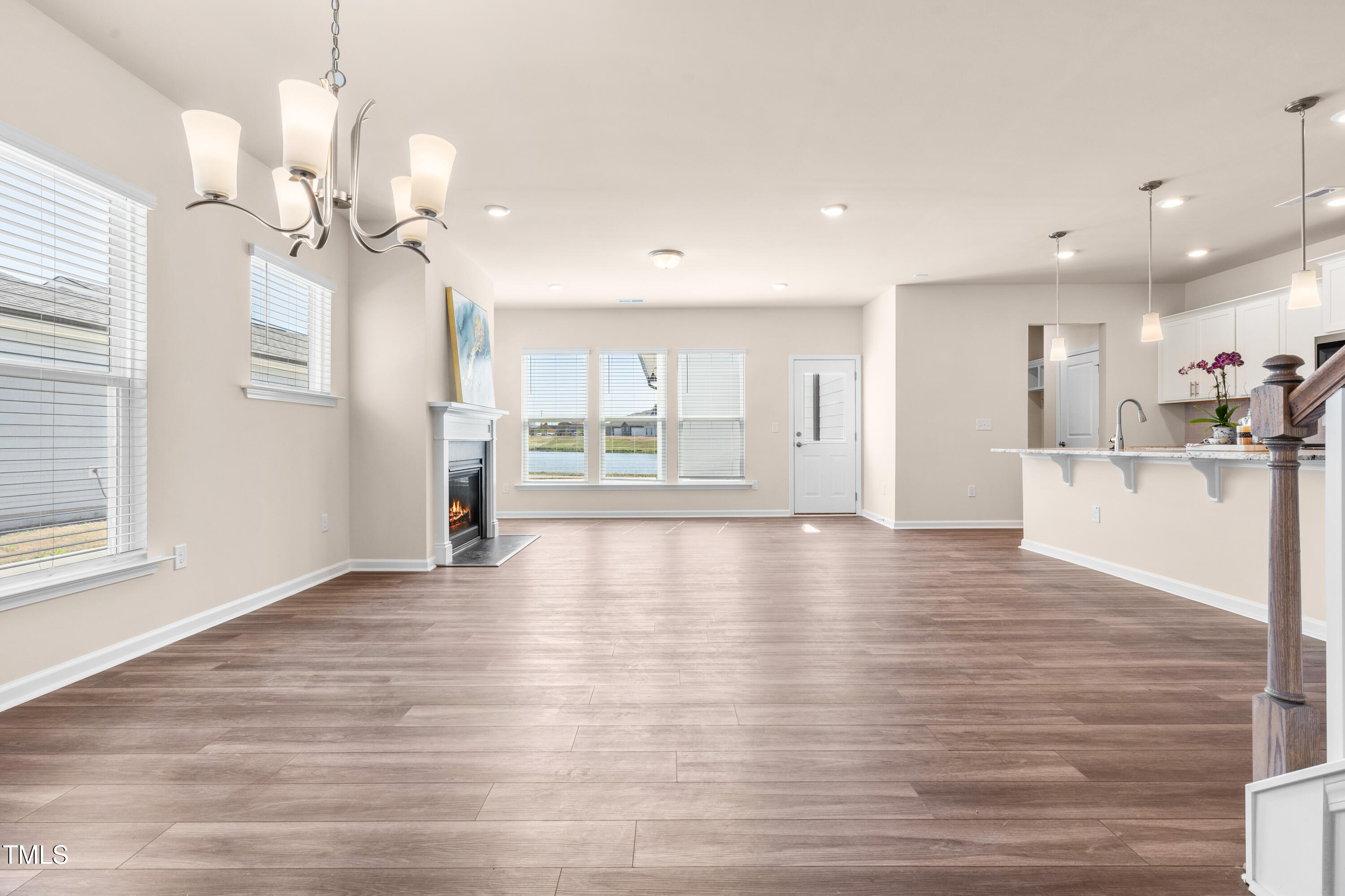 5800 Agrinio Way Raleigh, NC 27603 - Photo 12 of 38 a view of an empty room with kitchen and window