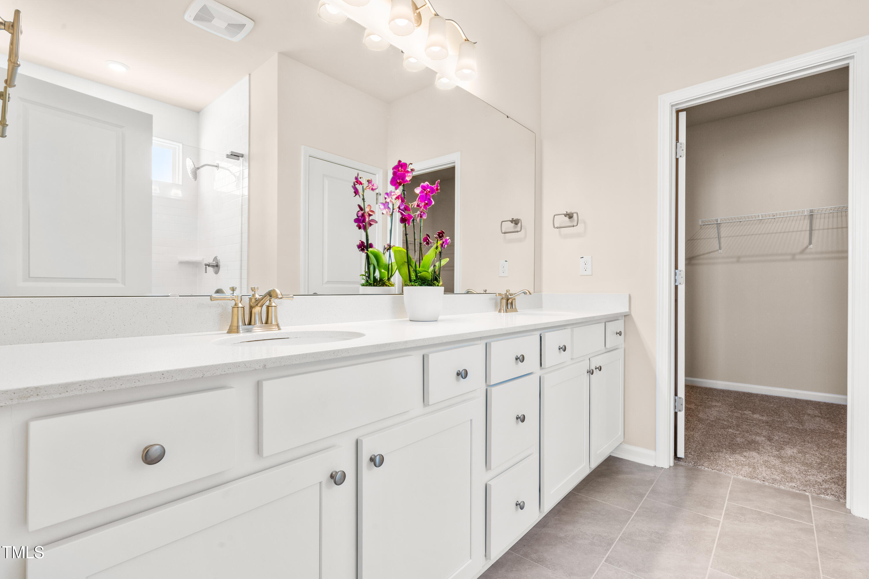 5800 Agrinio Way Raleigh, NC 27603 - Photo 15 of 38 a spacious bathroom with double sink and a mirror