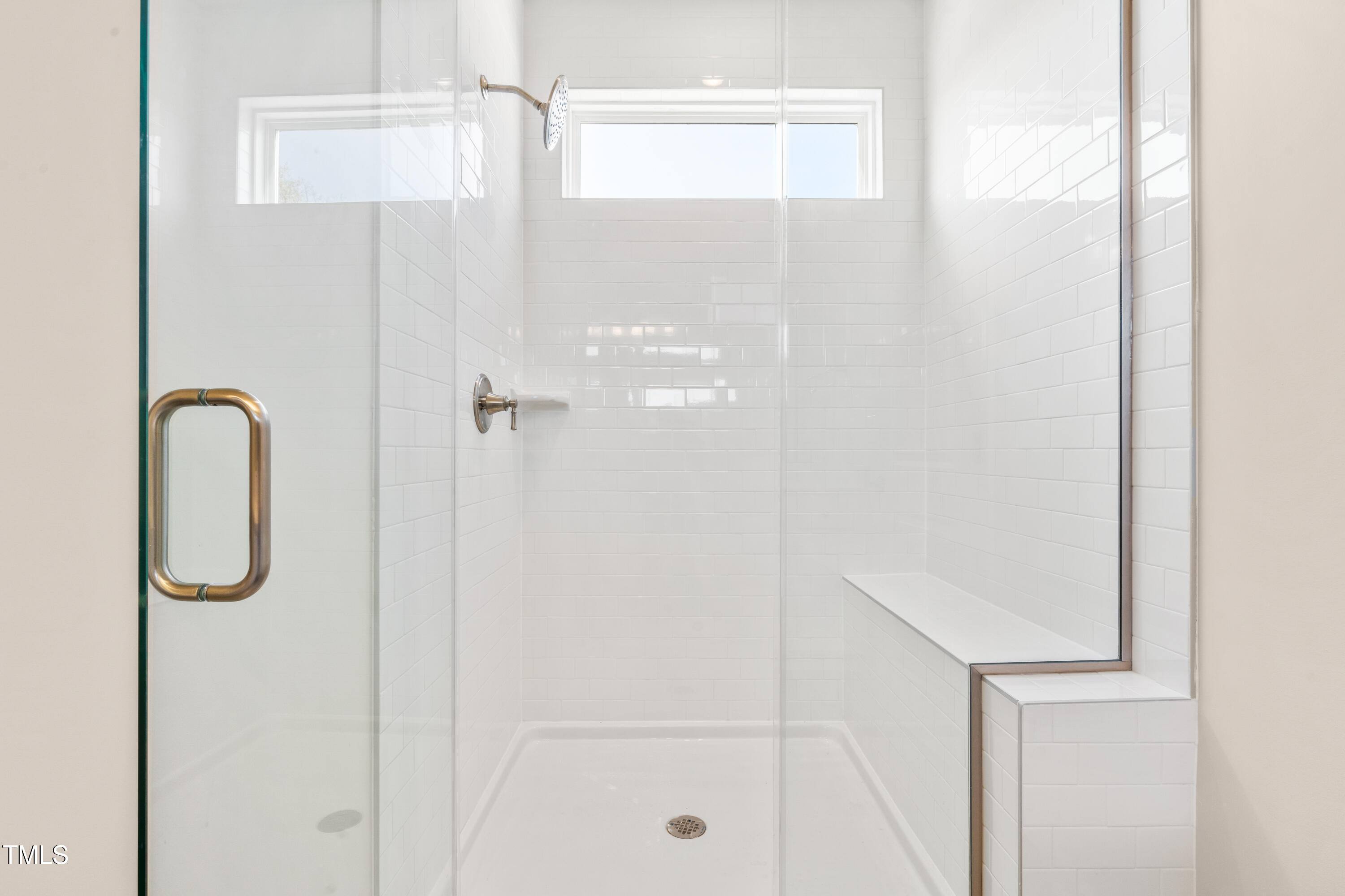 5800 Agrinio Way Raleigh, NC 27603 - Photo 16 of 38 a bathroom with a glass shower door
