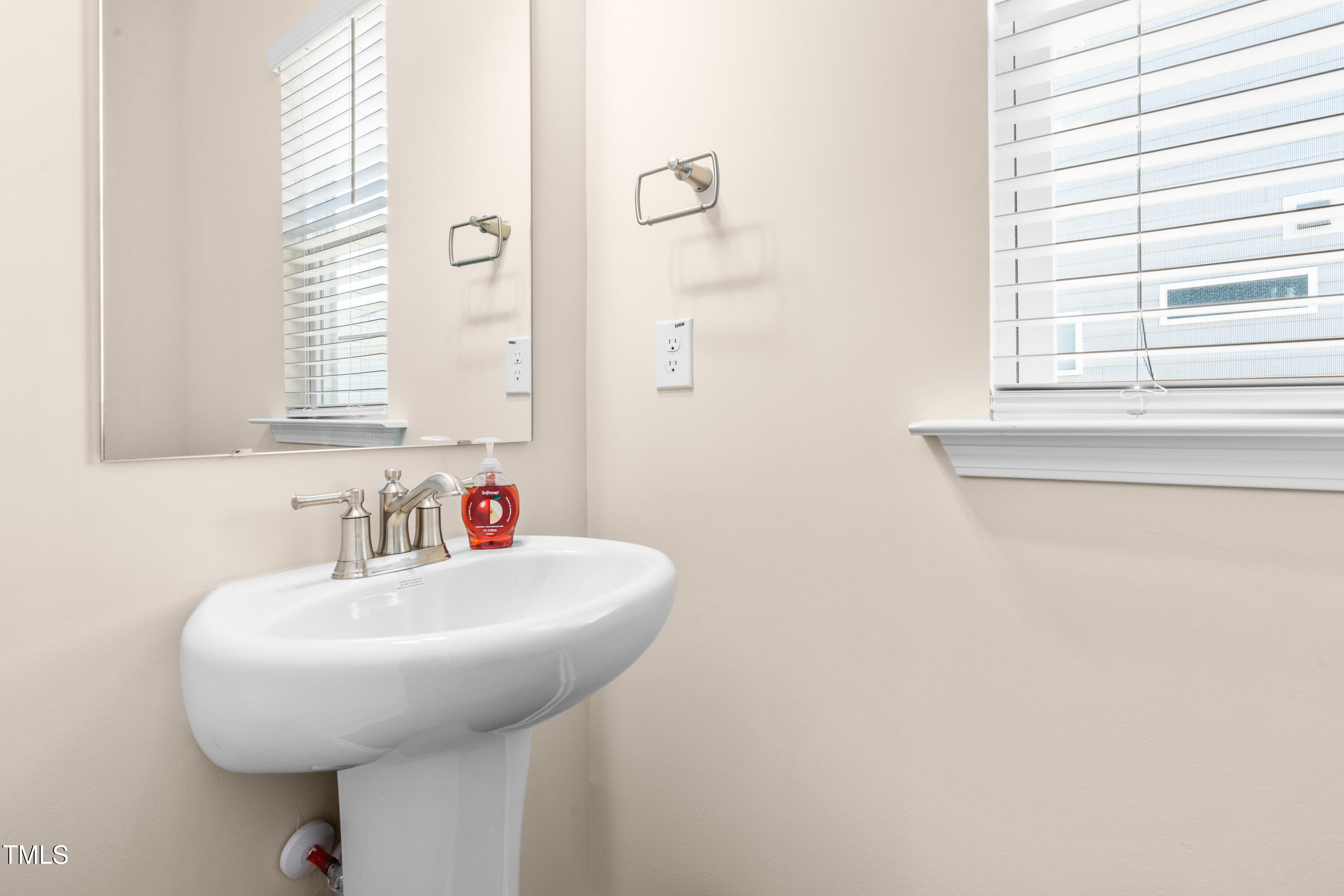5800 Agrinio Way Raleigh, NC 27603 - Photo 27 of 38 a bathroom with a sink and a mirror