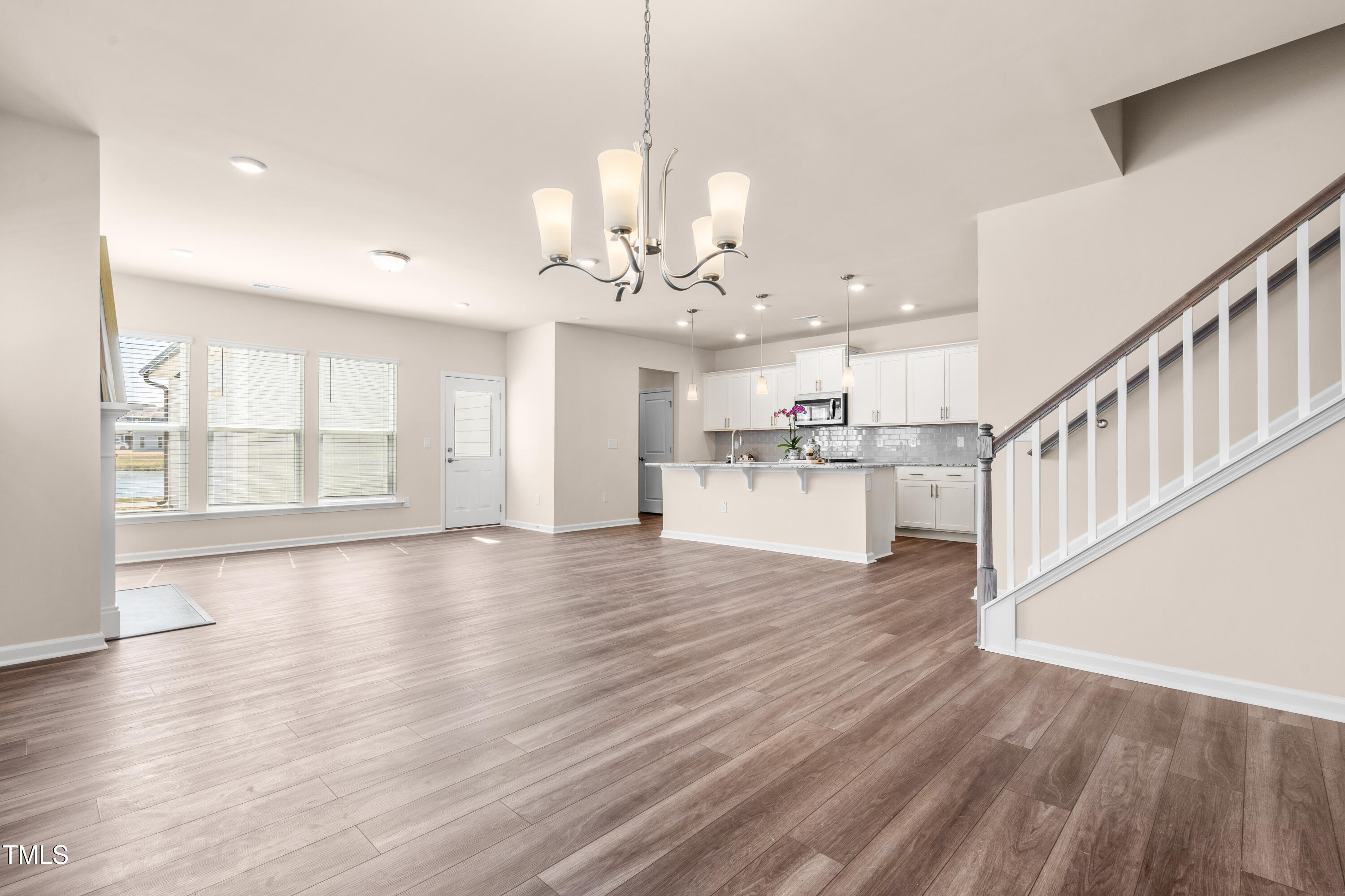 5800 Agrinio Way Raleigh, NC 27603 - Photo 3 of 38 a view of a kitchen with wooden floor and a window
