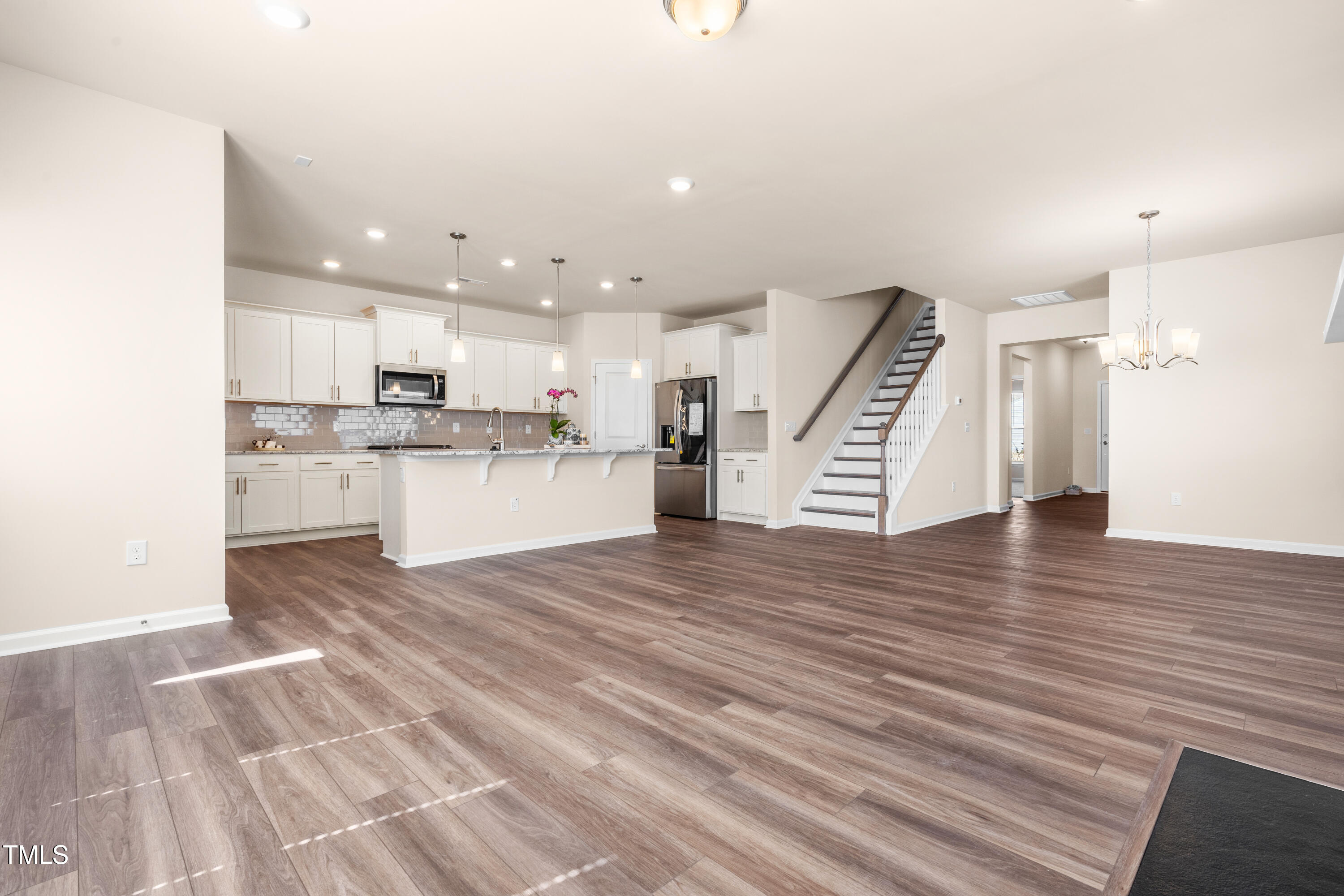 5800 Agrinio Way Raleigh, NC 27603 - Photo 8 of 38 a view of kitchen with cabinets stainless steel appliances and wooden floor