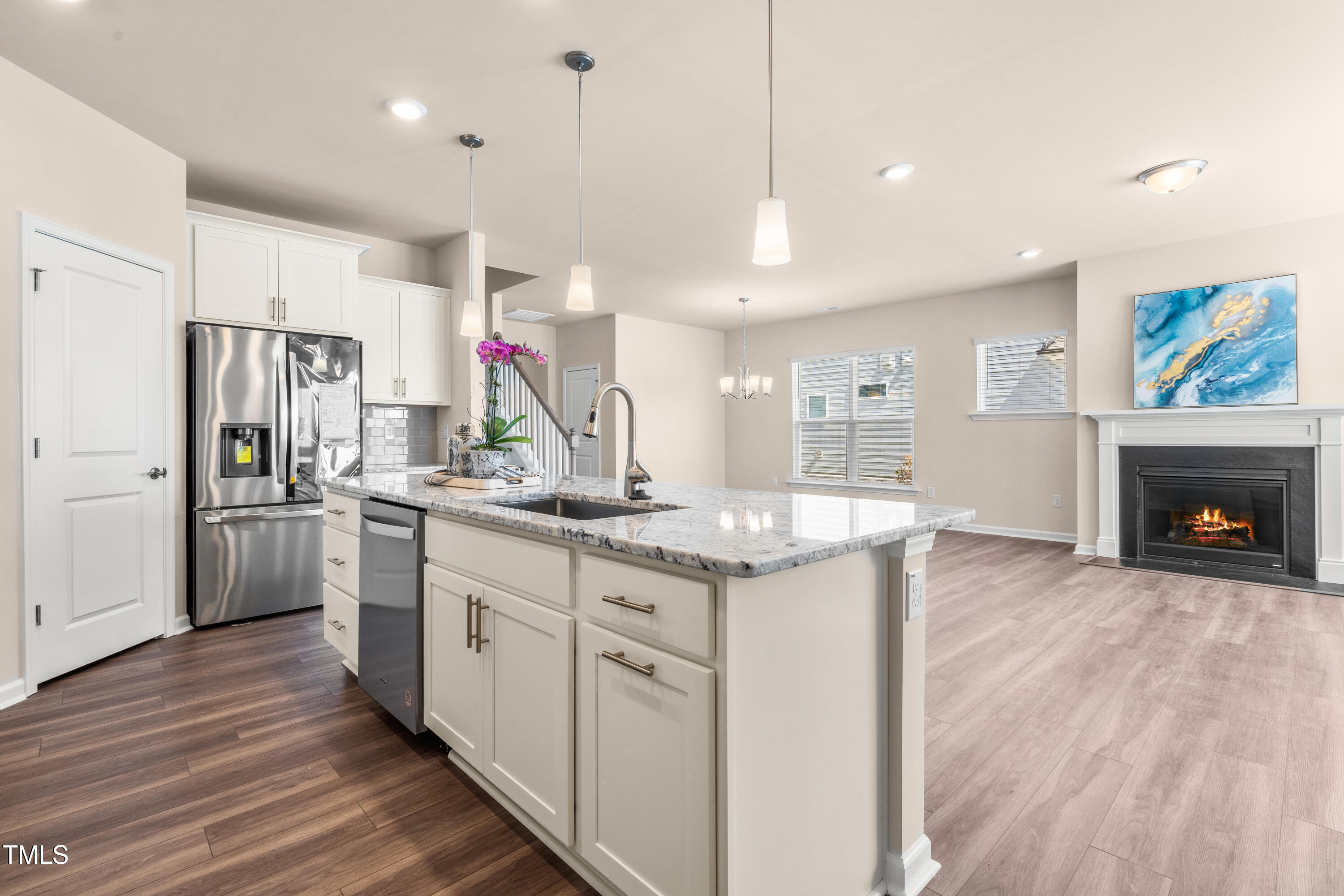 5800 Agrinio Way Raleigh, NC 27603 - Photo 9 of 38 a kitchen with stainless steel appliances granite countertop a refrigerator a oven a stove and a wooden floors