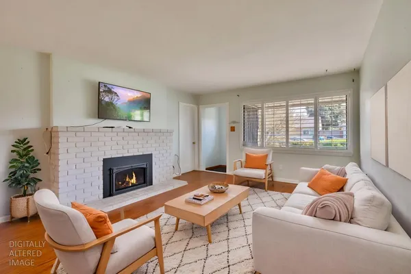 a living room with furniture a rug and a fireplace