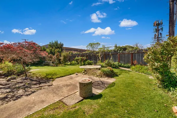 a house view with swimming pool and garden space