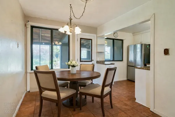 a dining room with furniture a chandelier and a rug
