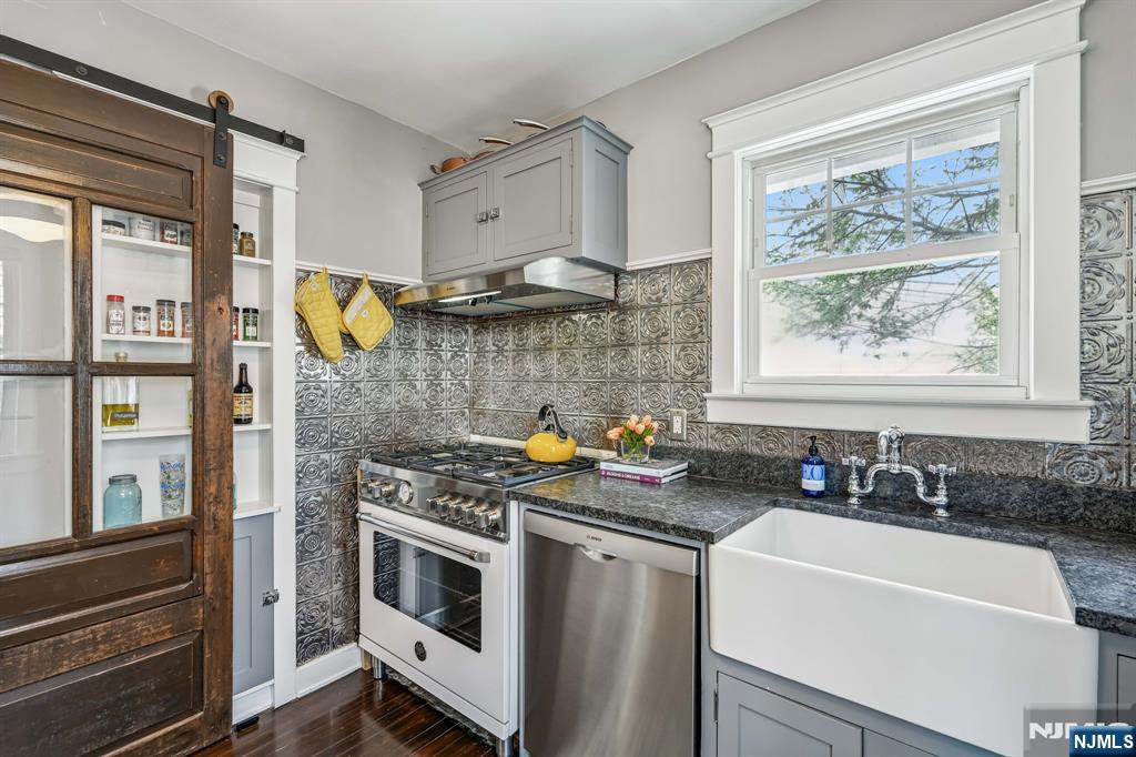 31 Nassau Road Montclair, NJ 07043 - Photo 12 of 33 a kitchen with stainless steel appliances a stove a sink and a microwave