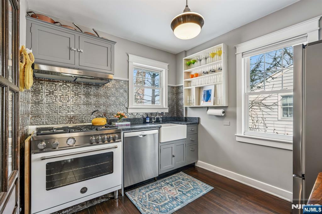 31 Nassau Road Montclair, NJ 07043 - Photo 15 of 33 a kitchen with stainless steel appliances a stove a sink and a microwave