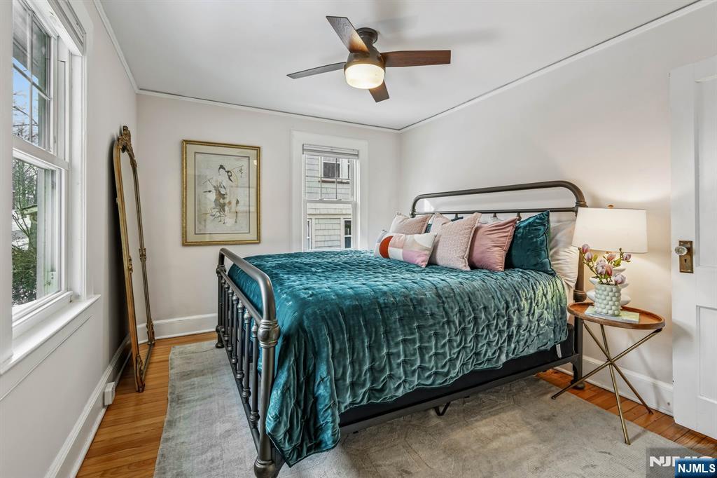 31 Nassau Road Montclair, NJ 07043 - Photo 16 of 33 a bedroom with a bed and a chandelier